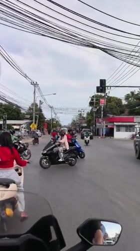 Busy tropical roads and hillside views across a Thai day
