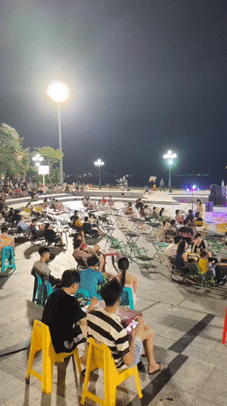 Live band plays waterfront stage under dove sculpture in Quy Nhon