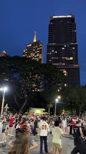 Diverse crowd gathers at Bangkok park during evening hours
