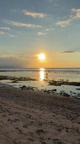 Sunset captured at Indonesian beach with golden reflections