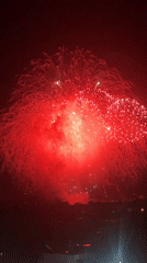 Red and white fireworks explode over Ottawa at night