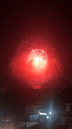Red and white fireworks explode over Ottawa at night