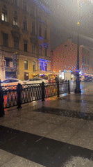Rainy evening street life documented near Saint Petersburg bars