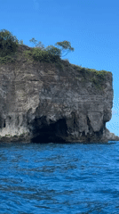 Tourist cave exploration and snorkeling at Nusa Penida cliffs