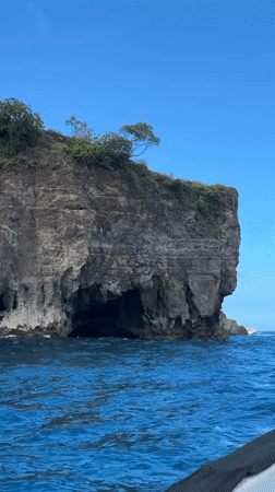 Tourist cave exploration and snorkeling at Nusa Penida cliffs