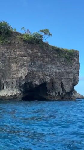 Tourist cave exploration and snorkeling at Nusa Penida cliffs