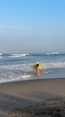 Late evening at North Kuta beach: surfers, strollers, and a toddler café view