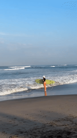 Late evening at North Kuta beach: surfers, strollers, and a toddler café view