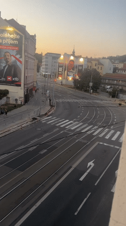 Tram tracks and ad-covered buildings on a Brno street