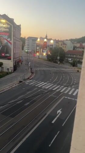 Tram tracks and ad-covered buildings on a Brno street