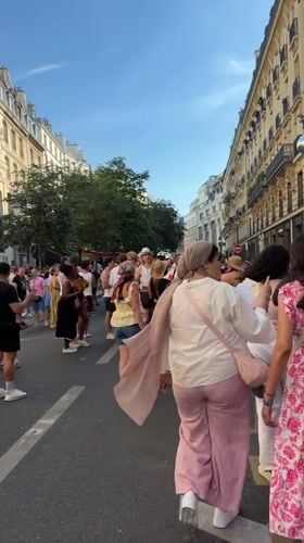 Summer crowds fill a lively Paris boulevard