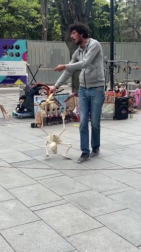 Street performer operates skeleton puppet in Stara Zagora park