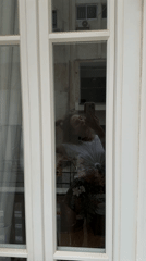 Woman takes flower bouquet selfie in Amman window reflection