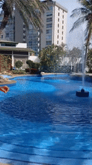 Pool scene with woman stretching, father present in Porlamar