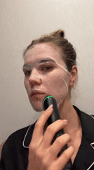 Woman performs evening skincare routine with LED beauty devices