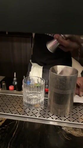 Bartender crafts cocktails during evening service at Cape Town ramen bar