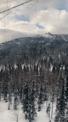 Ski lift passenger captures mountain vista from cabin