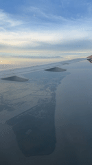 Passenger films aerial views of Surabaya coastline from airplane