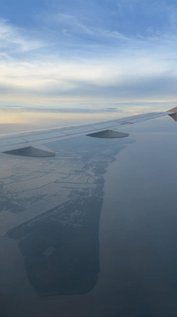Passenger films aerial views of Surabaya coastline from airplane