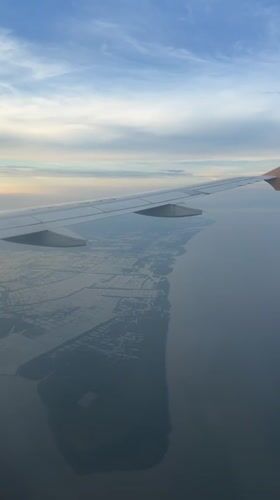 Passenger films aerial views of Surabaya coastline from airplane