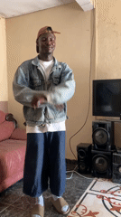 Young man dances, poses with bottle in Jos living room