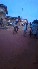 Dancing in a patterned dress at an outdoor community gathering