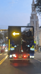Garbage collectors work evening shift on Miraflores street