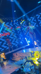 Red sequined stage performance, one performer front and center