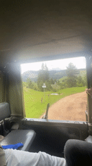 Military vehicle travels rural dirt road near Iagodina, Bulgaria
