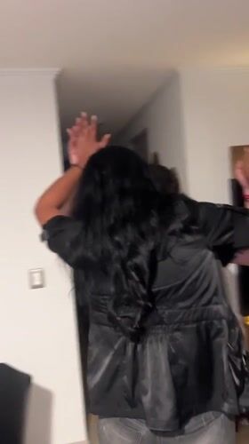 Couple dances indoors during early morning gathering in Arica