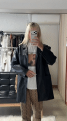 Person takes mirror selfie in fashionable outfit in Seoul