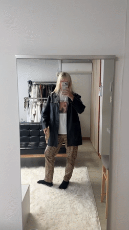 Person takes mirror selfie in fashionable outfit in Seoul