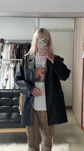 Person takes mirror selfie in fashionable outfit in Seoul