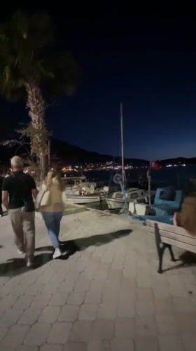 Evening life unfolds along Fethiye's moonlit waterfront promenade
