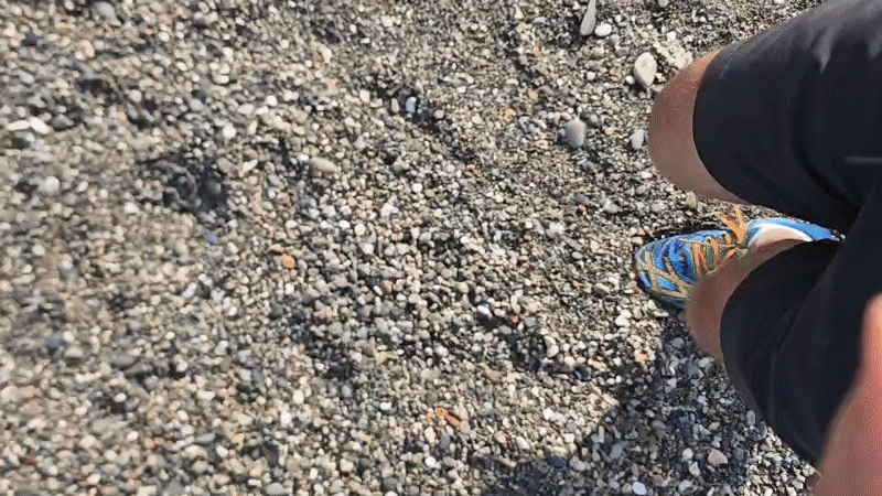 Person takes sunny beach walk in Chabkwara, Abkhazia