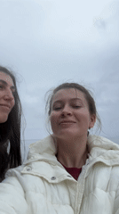 Women photographed at rocky beach in Kostovaty, Russia