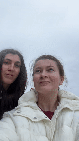 Women photographed at rocky beach in Kostovaty, Russia
