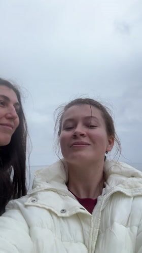 Women photographed at rocky beach in Kostovaty, Russia