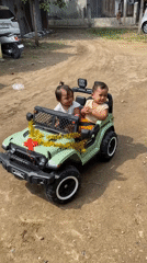 Children ride decorated toy jeep in Lhokseumawe Indonesia