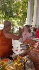 Buddhist monk conducts blessing ceremonies for visitors in Thailand