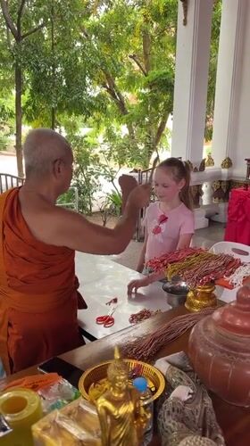 Buddhist monk conducts blessing ceremonies for visitors in Thailand