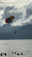 Beach day in Đà Nẵng — parasailing, sand, and the Navy Hotel
