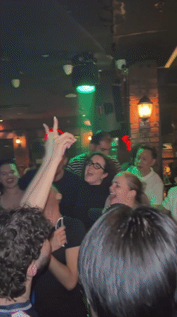 Nightclub scene in Liangjiang with DJ, dancing, and neon lights.