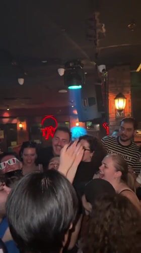 Nightclub scene in Liangjiang with DJ, dancing, and neon lights.