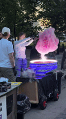 Street performers and cotton candy at dusk near the Admiralty