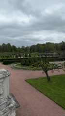 Tourist activities documented at Peterhof palace grounds on overcast day