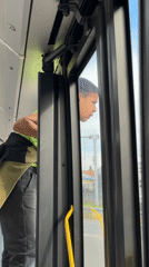 Boy peers from bus door in Belgrade suburb