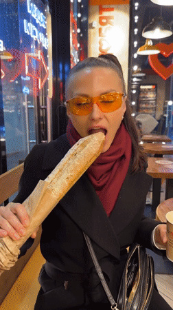 Woman enjoys baguette at Murino cafe Sunday evening
