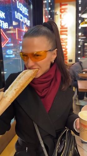 Woman enjoys baguette at Murino cafe Sunday evening