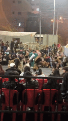 Traditional dancers perform outdoors at night in La Paz